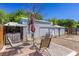 Backyard scene with patio seating, a metal shed, and lush trees offering privacy at 208 W Alma St, Overton, NV 89040