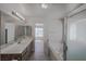 Bright bathroom features double vanity, tub, shower, and a connecting door to the bedroom at 208 W Alma St, Overton, NV 89040