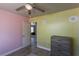 Colorful bedroom features wood-look tile floors, ceiling fan, and connecting door at 208 W Alma St, Overton, NV 89040