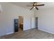 The neutral bedroom has wood-look tile floors, ceiling fan, and access to the bathroom and closet at 208 W Alma St, Overton, NV 89040