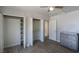 Bedroom with wood-look tile floor, closet, and dresser on light colored walls at 208 W Alma St, Overton, NV 89040