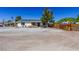 Quaint single-story home with a covered carport and a fenced yard, offering privacy and charm at 208 W Alma St, Overton, NV 89040