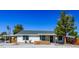 Charming single-story home with a spacious front yard and a covered carport at 208 W Alma St, Overton, NV 89040
