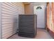View of house exterior with air conditioning unit near the back entry door at 208 W Alma St, Overton, NV 89040