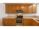 Bright kitchen with wood cabinetry, stainless steel oven and microwave, and plenty of counter space for cooking at 208 W Alma St, Overton, NV 89040