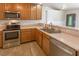 Functional kitchen area with a stainless steel oven, microwave, and dishwasher, and generous counter space at 208 W Alma St, Overton, NV 89040