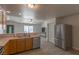 Open kitchen design with stainless steel refrigerator, dishwasher, and sink, ideal for modern living at 208 W Alma St, Overton, NV 89040