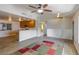 Spacious living room with a view of the kitchen, highlighted by a stylish rug and modern lighting at 208 W Alma St, Overton, NV 89040