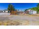 Exterior view of a playground with swingset and playhouse, perfect for outdoor fun at 208 W Alma St, Overton, NV 89040