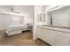 Bathroom featuring a large mirror and granite countertop vanity adjacent to a bedroom at 2451 N Rainbow Blvd # 2131, Las Vegas, NV 89108