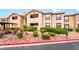View of the apartment exterior featuring well-maintained landscaping with rocks and green shrubs at 2451 N Rainbow Blvd # 2131, Las Vegas, NV 89108