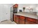 View of the kitchen with granite countertops, stainless steel refrigerator, and dark wood cabinets at 2451 N Rainbow Blvd # 2131, Las Vegas, NV 89108