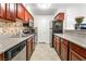 Galley kitchen with stainless steel appliances, granite countertops, and dark wood cabinets at 2451 N Rainbow Blvd # 2131, Las Vegas, NV 89108