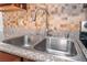 Close-up view of a double basin stainless steel kitchen sink with granite countertop at 2451 N Rainbow Blvd # 2131, Las Vegas, NV 89108