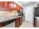 Galley kitchen with stainless steel appliances, granite countertops, and dark wood cabinets at 2451 N Rainbow Blvd # 2131, Las Vegas, NV 89108