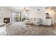 Living room featuring a fireplace, ceiling fan, sliding glass door leading to a balcony, and a wet bar at 2451 N Rainbow Blvd # 2131, Las Vegas, NV 89108