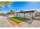 Home backyard featuring synthetic grass, desert landscaping, patio and a small swimming pool at 2529 Indian Sage Way, Las Vegas, NV 89108