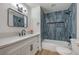 Newly renovated bathroom with white cabinets, a quartz countertop, and a tiled shower-tub combo at 2529 Indian Sage Way, Las Vegas, NV 89108