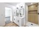 Stylish bathroom features double sinks, modern light fixtures, and a glass-enclosed shower with tiled accents at 2529 Indian Sage Way, Las Vegas, NV 89108