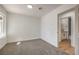 Bedroom featuring neutral paint, gray carpet, and bathroom access at 2529 Indian Sage Way, Las Vegas, NV 89108