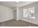 Small bedroom featuring carpet floors, closet, and a window overlooking desert landscaping at 2529 Indian Sage Way, Las Vegas, NV 89108