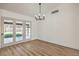 Bright dining room with French doors leading to the backyard and wood-look flooring at 2529 Indian Sage Way, Las Vegas, NV 89108