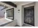 Home entryway with a security door, stucco walls, and desert landscaping at 2529 Indian Sage Way, Las Vegas, NV 89108