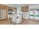 Bright kitchen features modern stainless steel appliances, wood cabinets, white countertops, and breakfast bar seating at 2529 Indian Sage Way, Las Vegas, NV 89108