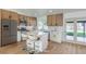 Bright kitchen features stainless steel appliances, white countertops, and a center island with bar seating at 2529 Indian Sage Way, Las Vegas, NV 89108