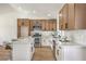 Modern kitchen with quartz countertops, wood cabinets, and stainless steel appliances at 2529 Indian Sage Way, Las Vegas, NV 89108