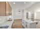 Lovely kitchen with quartz counters, tile backsplash, stainless appliances, and view to living and dining area at 2529 Indian Sage Way, Las Vegas, NV 89108