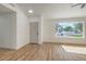 Bright living room with wood-look floors, fresh white paint, and a large picture window at 2529 Indian Sage Way, Las Vegas, NV 89108