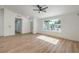 Bright living room boasts wood-look floors, ceiling fan, and a large picture window to bring the outside in at 2529 Indian Sage Way, Las Vegas, NV 89108