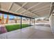 Outdoor patio with large covered seating area, synthetic grass lawn, and desert landscaping at 2529 Indian Sage Way, Las Vegas, NV 89108