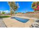 Home backyard with desert landscaping featuring a small swimming pool and privacy wall at 2529 Indian Sage Way, Las Vegas, NV 89108