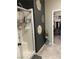 Modern shower with sleek glass door, tile surround, and walk in closet at 2585 Amazing Meadows Ave # 1007, North Las Vegas, NV 89031