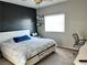 Bedroom with a black accent wall, a large window and modern style ceiling fan at 2585 Amazing Meadows Ave # 1007, North Las Vegas, NV 89031