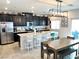 Modern kitchen with granite countertops, black cabinetry, and stainless steel appliances at 2585 Amazing Meadows Ave # 1007, North Las Vegas, NV 89031