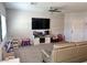 Bright living room with carpet flooring, ceiling fan, a white-paneled accent wall, and ample natural light at 2585 Amazing Meadows Ave # 1007, North Las Vegas, NV 89031