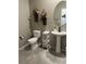 A powder room with a pedestal sink, a modern toilet, and decorative floral accents at 2585 Amazing Meadows Ave # 1007, North Las Vegas, NV 89031