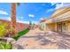 Beautiful backyard featuring desert landscaping, a privacy wall, and brick pavers at 2601 Bechamel Pl, Henderson, NV 89044