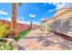 Beautiful backyard featuring desert landscaping, a privacy wall, and brick pavers at 2601 Bechamel Pl, Henderson, NV 89044