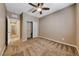 Comfortable bedroom featuring ceiling fan, closet with sliding doors, and hallway access at 2601 Bechamel Pl, Henderson, NV 89044