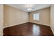 Cozy bedroom featuring dark hardwood floors and a window with bright, natural light at 2601 Bechamel Pl, Henderson, NV 89044