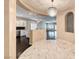 Open-concept dining room with stylish chandelier, views of kitchen, and neutral color palette at 2601 Bechamel Pl, Henderson, NV 89044