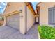 Inviting home entrance with a paved walkway leading to a covered front door and a two-car garage at 2601 Bechamel Pl, Henderson, NV 89044
