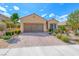 Charming single-story home featuring a well-manicured front yard and a two-car garage at 2601 Bechamel Pl, Henderson, NV 89044