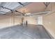 Spacious garage with epoxy flooring, hanging storage racks, and utilities at 2601 Bechamel Pl, Henderson, NV 89044