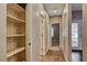 Neutral hallway with carpet, access to rooms, and a built-in shelved storage at 2601 Bechamel Pl, Henderson, NV 89044