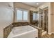 Bright main bathroom with separate shower and soaking tub with tiled surround at 2601 Bechamel Pl, Henderson, NV 89044